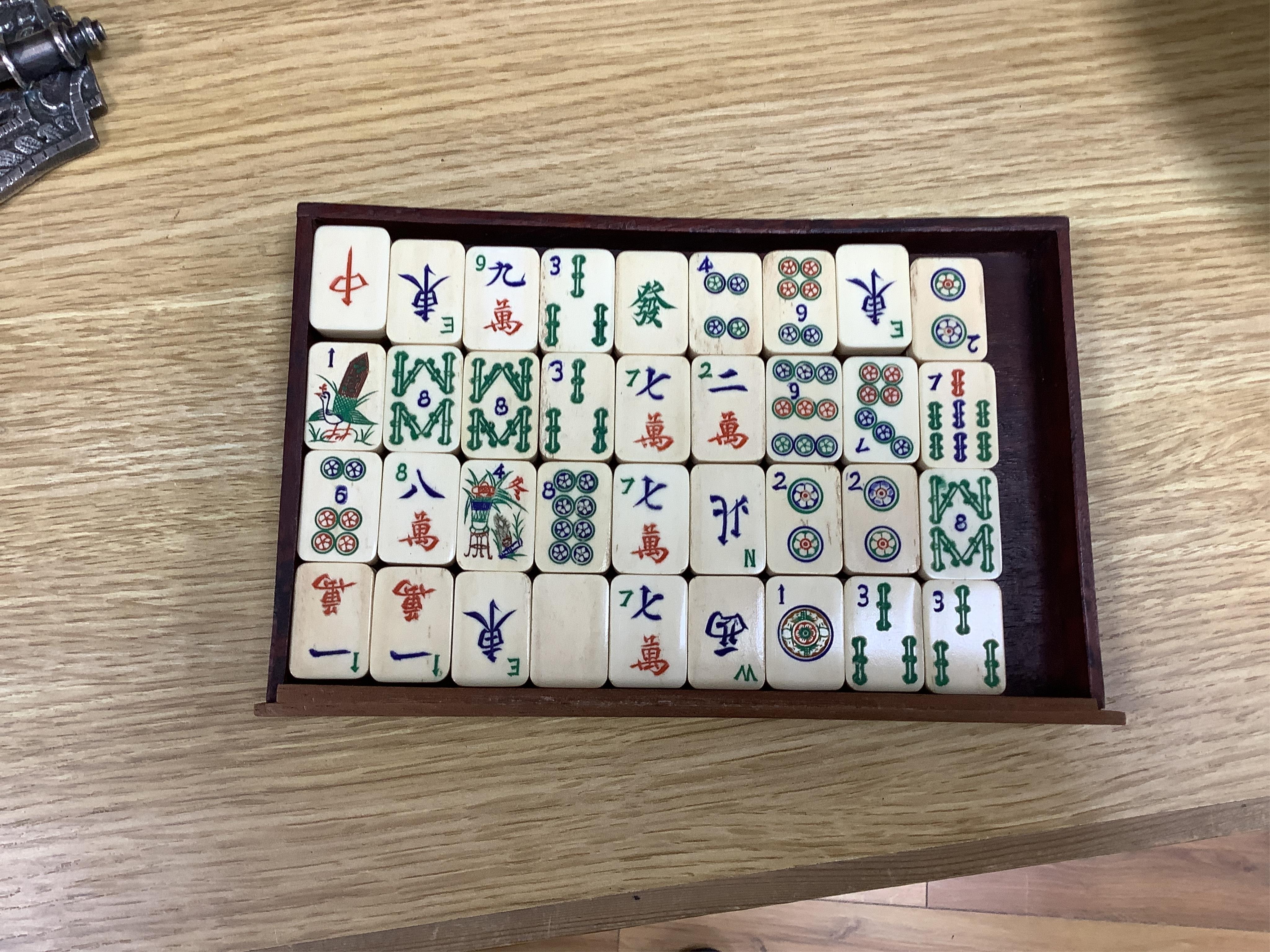 An early 20th century Chinese Mah Jong set, with bone tiles, 22cm x 15.5cm x 14.5cm. Condition - fair, one drawer front replaced